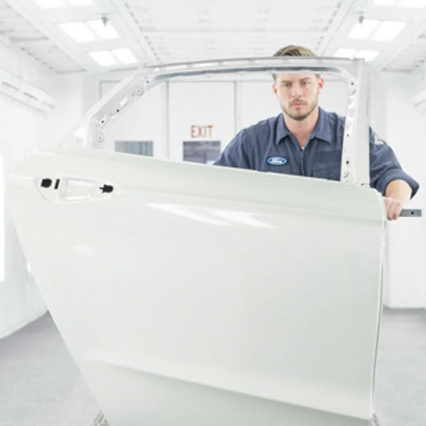 repair tech with car door John Wiese Ford in Sauk Centre MN